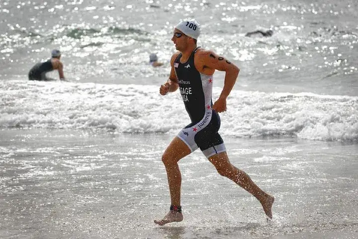 Solo male runner jogging on beach